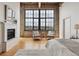 Bedroom featuring a cozy seating area by a large window and a modern fireplace at 2000 Little Raven St # 4A, Denver, CO 80202