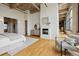 Spacious bedroom with concrete ceilings, fireplace, and hardwood flooring at 2000 Little Raven St # 4A, Denver, CO 80202