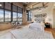 Bedroom with large windows showcasing city views and a stylish seating area at 2000 Little Raven St # 4A, Denver, CO 80202