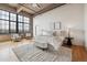 Bright bedroom with large windows, hardwood floors, and a comfortable bed with soft textures at 2000 Little Raven St # 4A, Denver, CO 80202