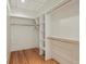 Walk-in closet featuring built-in shelving and hardwood flooring at 2000 Little Raven St # 4A, Denver, CO 80202
