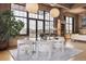 View of the dining area with large windows, modern furniture, a tree, and hanging lights at 2000 Little Raven St # 4A, Denver, CO 80202