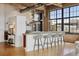 Bright, open kitchen with concrete island, stainless hood, bar seating, and views at 2000 Little Raven St # 4A, Denver, CO 80202