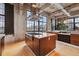 Spacious kitchen featuring large island, stainless hood, and city views at 2000 Little Raven St # 4A, Denver, CO 80202