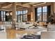 Bright living room featuring exposed concrete, large windows, hardwood floors, and modern furnishings at 2000 Little Raven St # 4A, Denver, CO 80202