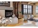 Living room featuring a modern fireplace, jukebox, plush seating, and large window with a view at 2000 Little Raven St # 4A, Denver, CO 80202