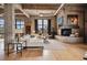 Spacious living room boasts a fireplace, hardwood floors, and large windows offering city views at 2000 Little Raven St # 4A, Denver, CO 80202