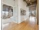 Spacious living room with hardwood floors, exposed pipes, and open door to the bedroom at 2000 Little Raven St # 4A, Denver, CO 80202