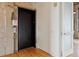 A modern black elevator next to a light and open doorway showcasing hardwood floors at 2000 Little Raven St # 4A, Denver, CO 80202