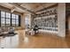 Bright home office with floor to ceiling bookshelves, large windows, and wood floors at 2000 Little Raven St # 4A, Denver, CO 80202
