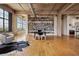 Bright office space with a wall of built-in bookshelves, large windows, and hardwood floors at 2000 Little Raven St # 4A, Denver, CO 80202