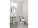 Simple bathroom with pedestal sink, toilet, and oval mirror at 13432 Wabash St, Thornton, CO 80602