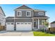 Two-story house with gray siding, white trim, and a two-car garage at 13432 Wabash St, Thornton, CO 80602