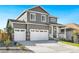 Two-story house with gray siding, white trim, and a two-car garage at 13432 Wabash St, Thornton, CO 80602