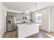 Modern kitchen with gray cabinets, island, and stainless steel appliances at 13432 Wabash St, Thornton, CO 80602