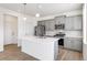 Modern kitchen with gray cabinets, island, and stainless steel appliances at 13432 Wabash St, Thornton, CO 80602