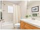 Well-lit bathroom with a tub and shower, vanity, and neutral finishes that create a clean and inviting space at 30205 Telluride Ln, Evergreen, CO 80439