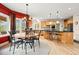 Bright breakfast nook featuring a stone table, and views into the kitchen with an island and barstool seating at 30205 Telluride Ln, Evergreen, CO 80439