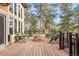 Wooden deck with an outdoor fire pit and seating area for entertaining at 30205 Telluride Ln, Evergreen, CO 80439