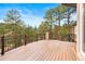 Spacious deck with wood flooring and metal railings offering stunning views of the surrounding landscape at 30205 Telluride Ln, Evergreen, CO 80439