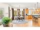 Sunlit dining area adjacent to kitchen featuring bay windows and hardwood floors at 30205 Telluride Ln, Evergreen, CO 80439