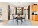 Bright dining area with large windows, hardwood floors, and elegant lighting fixtures at 30205 Telluride Ln, Evergreen, CO 80439