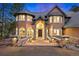 Impressive home entrance featuring stone accents, an arched doorway, and a well lit entrance at 30205 Telluride Ln, Evergreen, CO 80439