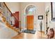 Bright foyer featuring high ceilings, a decorative front door, and hardwood floors at 30205 Telluride Ln, Evergreen, CO 80439