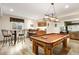 Entertaining game room with a pool table, wet bar, and adjacent seating area for relaxed gatherings at 30205 Telluride Ln, Evergreen, CO 80439