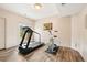 Home gym featuring a treadmill, stationary bike, and sliding glass doors leading to the outdoors at 30205 Telluride Ln, Evergreen, CO 80439