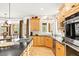 Bright kitchen with custom cabinetry, gas range, and black countertops at 30205 Telluride Ln, Evergreen, CO 80439