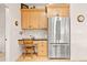 Efficient kitchen area featuring a stainless refrigerator, desk, upper cabinets and plenty of storage at 30205 Telluride Ln, Evergreen, CO 80439