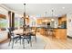 Open kitchen and dining area with black countertops and stainless steel appliances at 30205 Telluride Ln, Evergreen, CO 80439