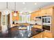 Bright and modern kitchen with stainless steel appliances, black countertops, and custom cabinetry at 30205 Telluride Ln, Evergreen, CO 80439