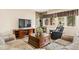 Comfortable living room with stacked stone accents, entertainment area and chairs at 30205 Telluride Ln, Evergreen, CO 80439