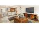 Spacious living room featuring a comfortable leather sectional, coffee table, and entertainment center with a large TV at 30205 Telluride Ln, Evergreen, CO 80439