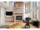 Cozy living room featuring a stone fireplace, large windows, and comfortable seating at 30205 Telluride Ln, Evergreen, CO 80439