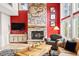 Cozy living room features a stone fireplace, large windows, TV and stylish decor at 30205 Telluride Ln, Evergreen, CO 80439