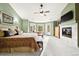 Large bedroom with fireplace, sitting area and a private deck overlooking the surrounding trees at 30205 Telluride Ln, Evergreen, CO 80439