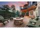 Outdoor deck with stone fireplace, fire pit, and scenic views; great for relaxing and entertaining at 30205 Telluride Ln, Evergreen, CO 80439
