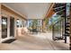 Covered patio with outdoor seating and a spiral staircase to the upper level at 30205 Telluride Ln, Evergreen, CO 80439