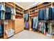 Organized walk-in closet featuring custom wooden shelving and ample storage space for clothing at 30205 Telluride Ln, Evergreen, CO 80439