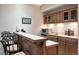 Features a sink, mini-refrigerator, and custom cabinetry for storage and serving at 30205 Telluride Ln, Evergreen, CO 80439