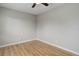A bedroom shows neutral walls, a ceiling fan, and wood-look floors for a cozy, simple appeal at 3355 S Flower St # 166, Lakewood, CO 80227