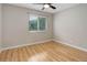Bright bedroom with hardwood floors, ceiling fan, and window for natural light at 3355 S Flower St # 166, Lakewood, CO 80227