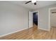 Bedroom features hardwood flooring, ceiling fan and a doorway leading to the staircase at 3355 S Flower St # 166, Lakewood, CO 80227
