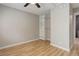 This bedroom offers a closet, shelving, and space with hardwood floors and natural light at 3355 S Flower St # 166, Lakewood, CO 80227