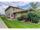 Inviting exterior of townhome with lush lawn, mature bushes, and siding and brick accents at 3355 S Flower St # 166, Lakewood, CO 80227