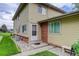 Charming townhome featuring a welcoming front entrance, complemented by a well-maintained lawn and landscape at 3355 S Flower St # 166, Lakewood, CO 80227