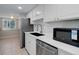 A modern kitchen features white cabinets, stainless steel appliances, and updated countertops at 3355 S Flower St # 166, Lakewood, CO 80227